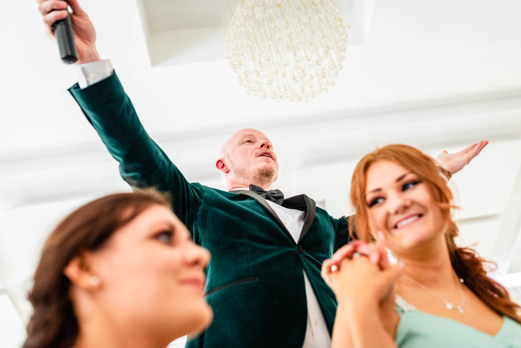 wedding singer raises arms 