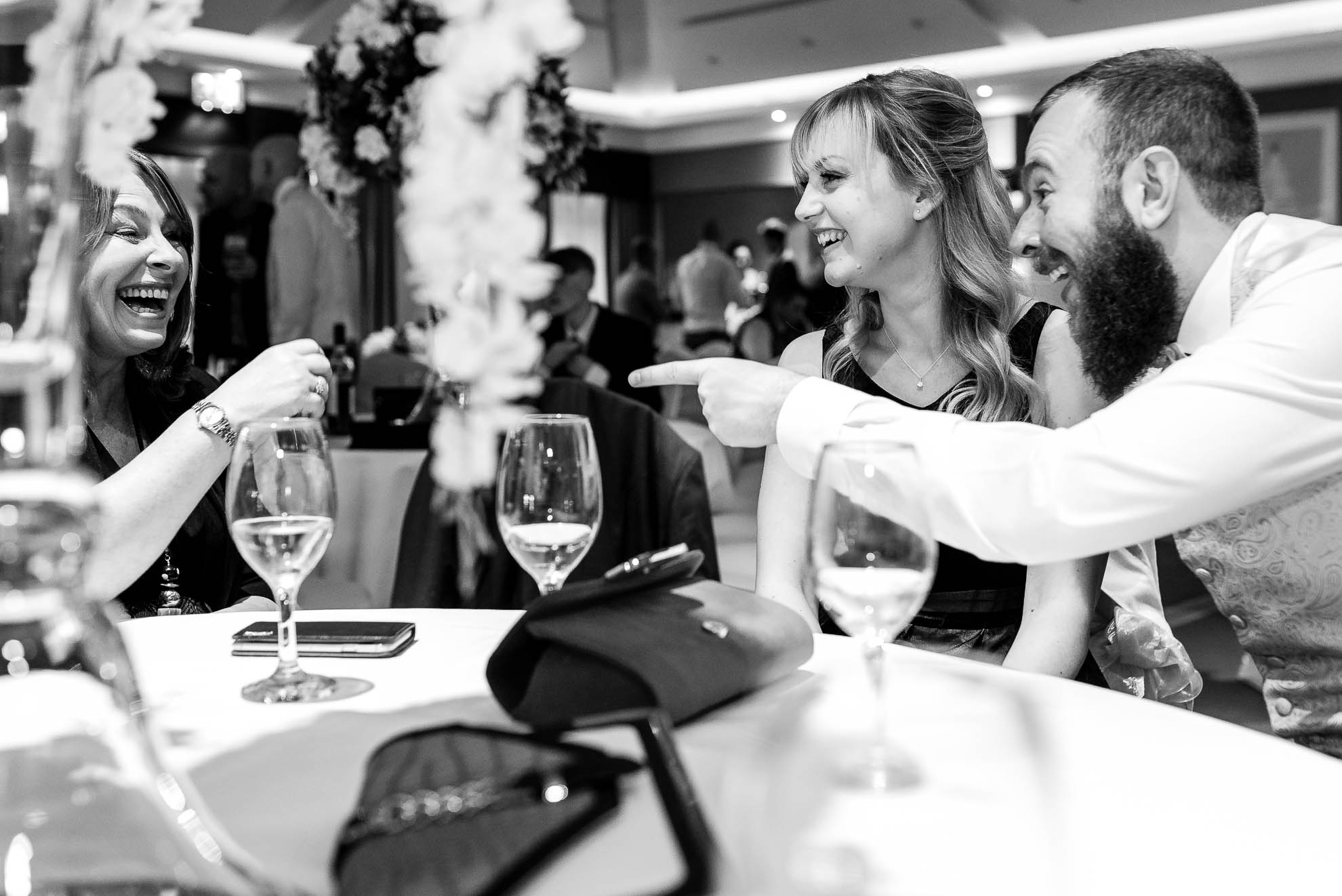 Best man shares a joke with guest