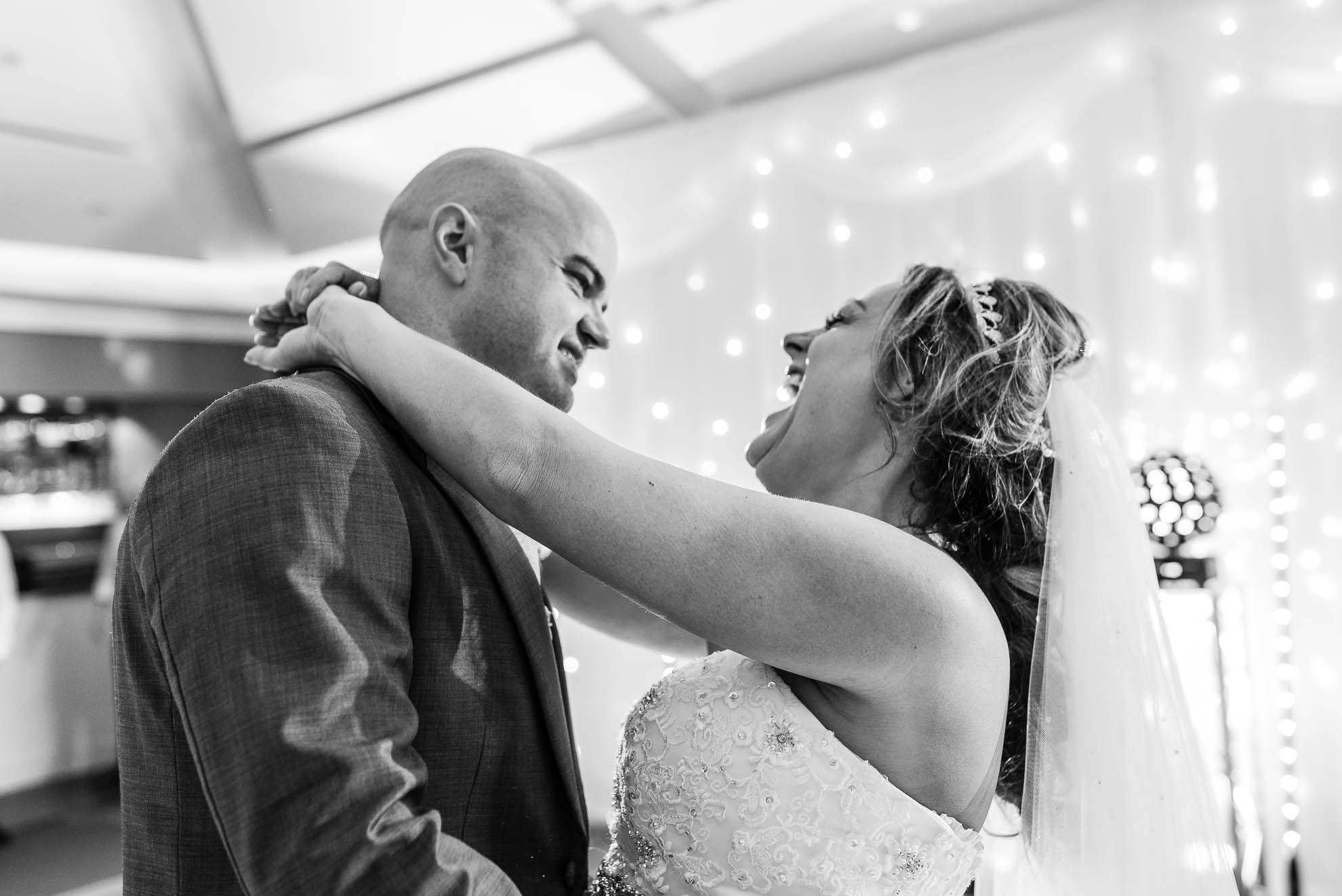 Bride and groom laughing during first dance