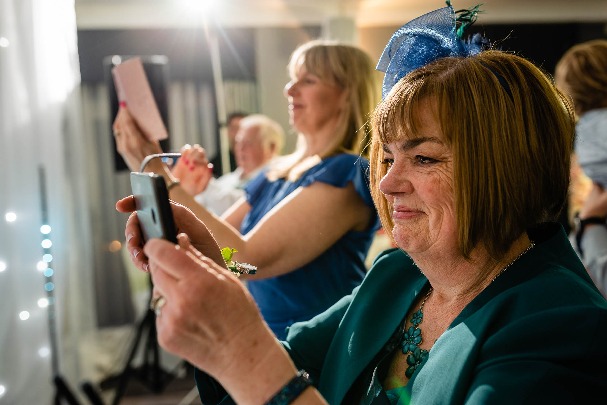 Mother of the groom taking photographs of the first dance