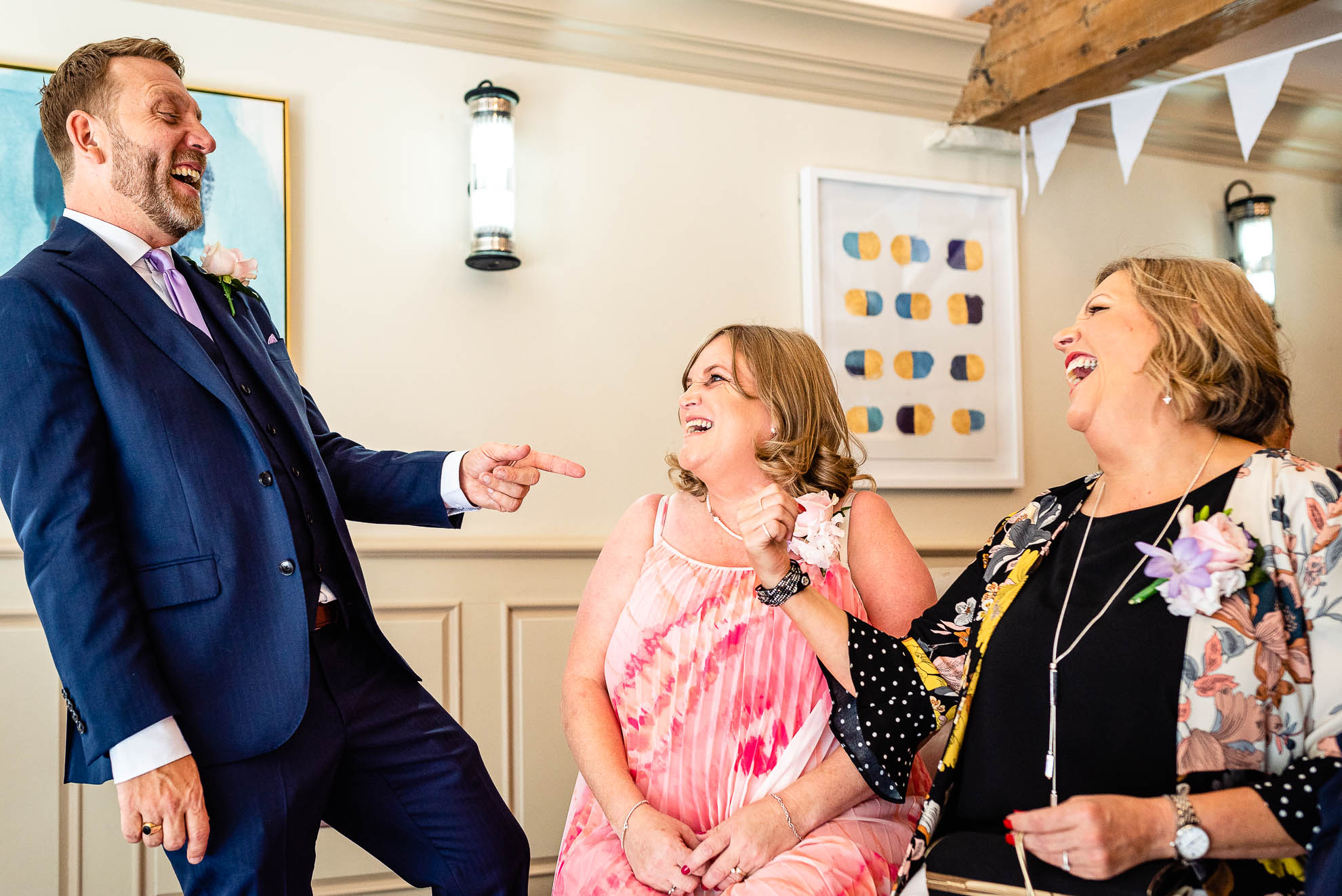 Groom shares a joke with his sisters