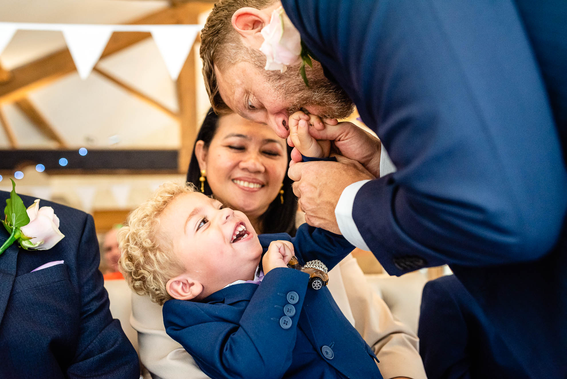 Groom plays with his son