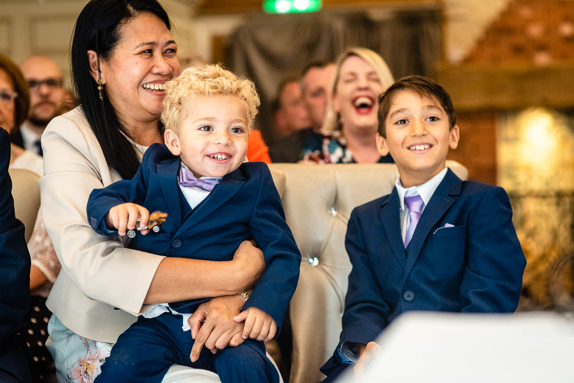 Bride and grooms sons laughing during the ceremony
