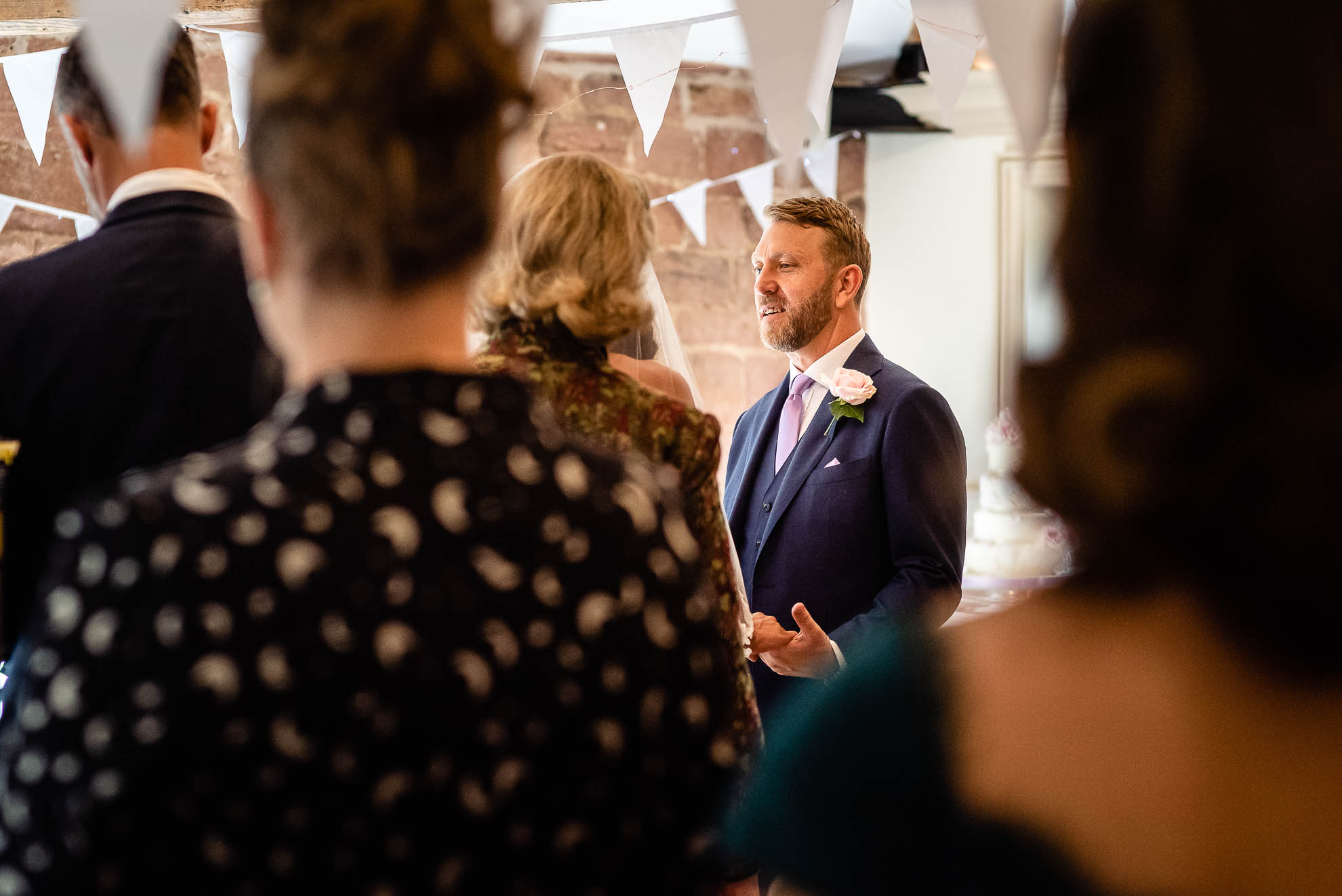 Groom looks at his bride during the ceremony
