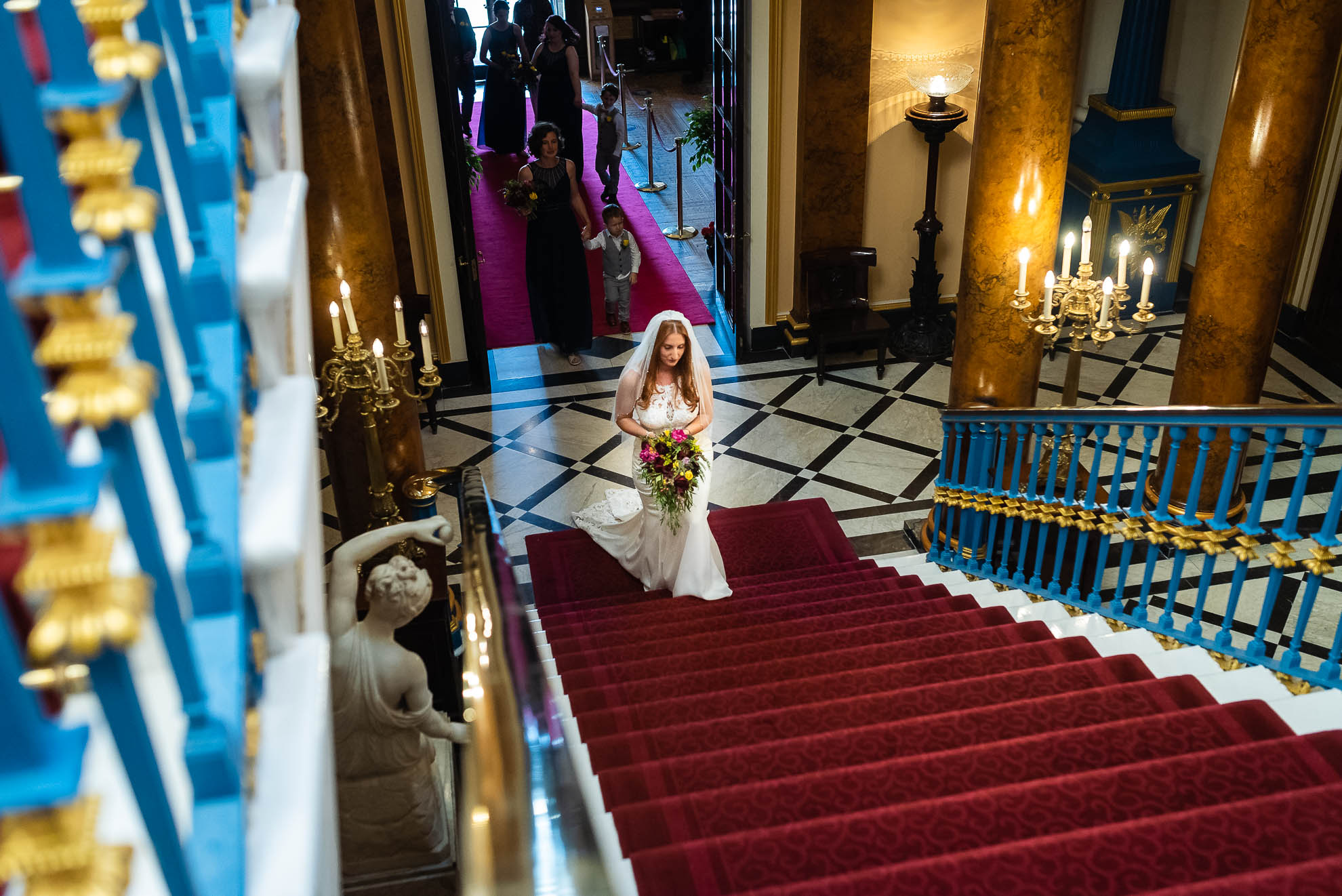 Bride walks up town hall stairs