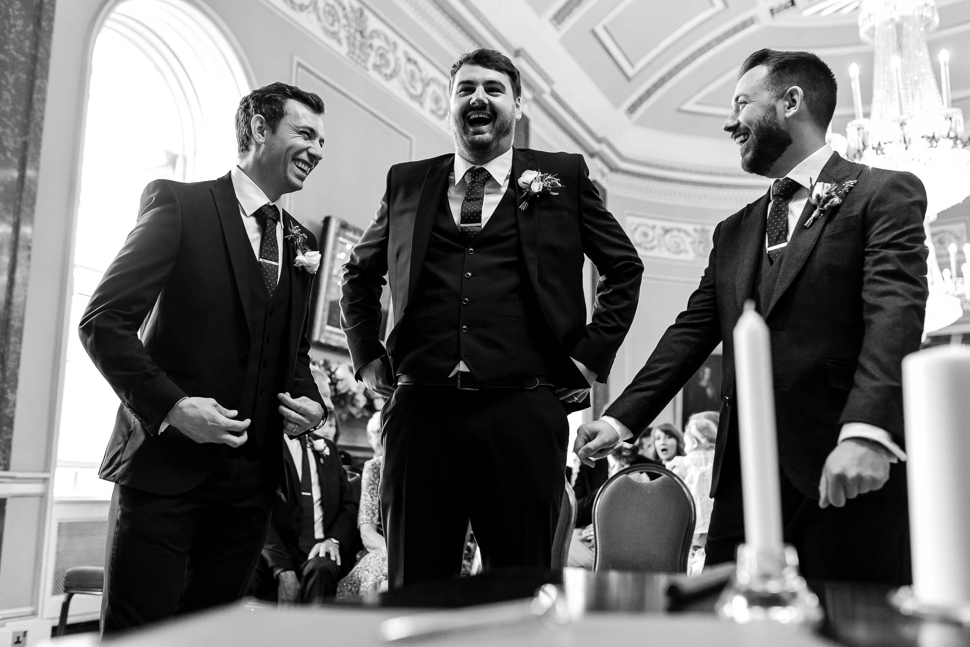 Groom shares a joke with his groomsmen