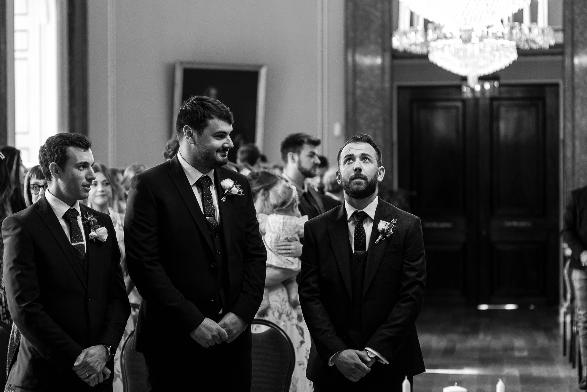 Groom looks nervous as he waits for his bride