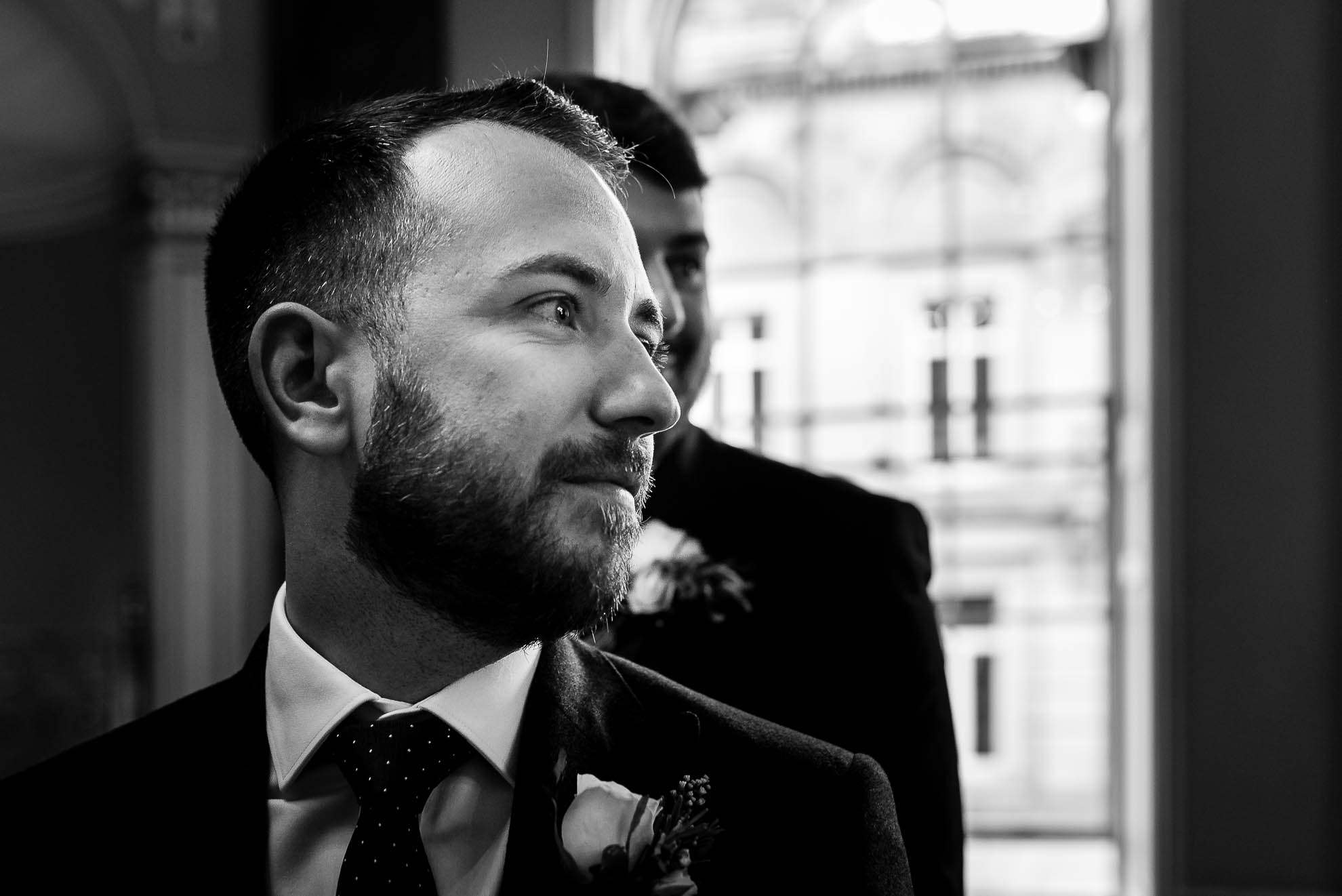Groom watches his bride walk up the aisle