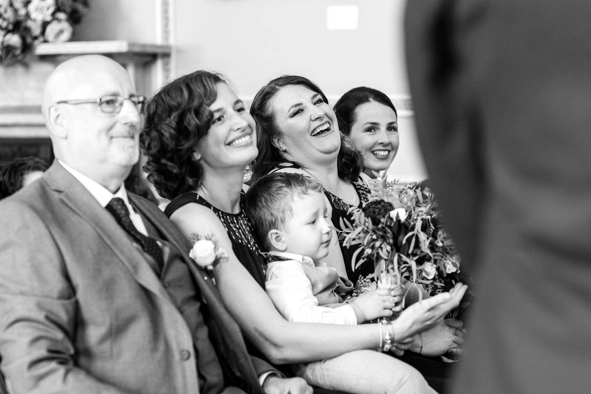 Bridesmaids share a joke during the ceremony