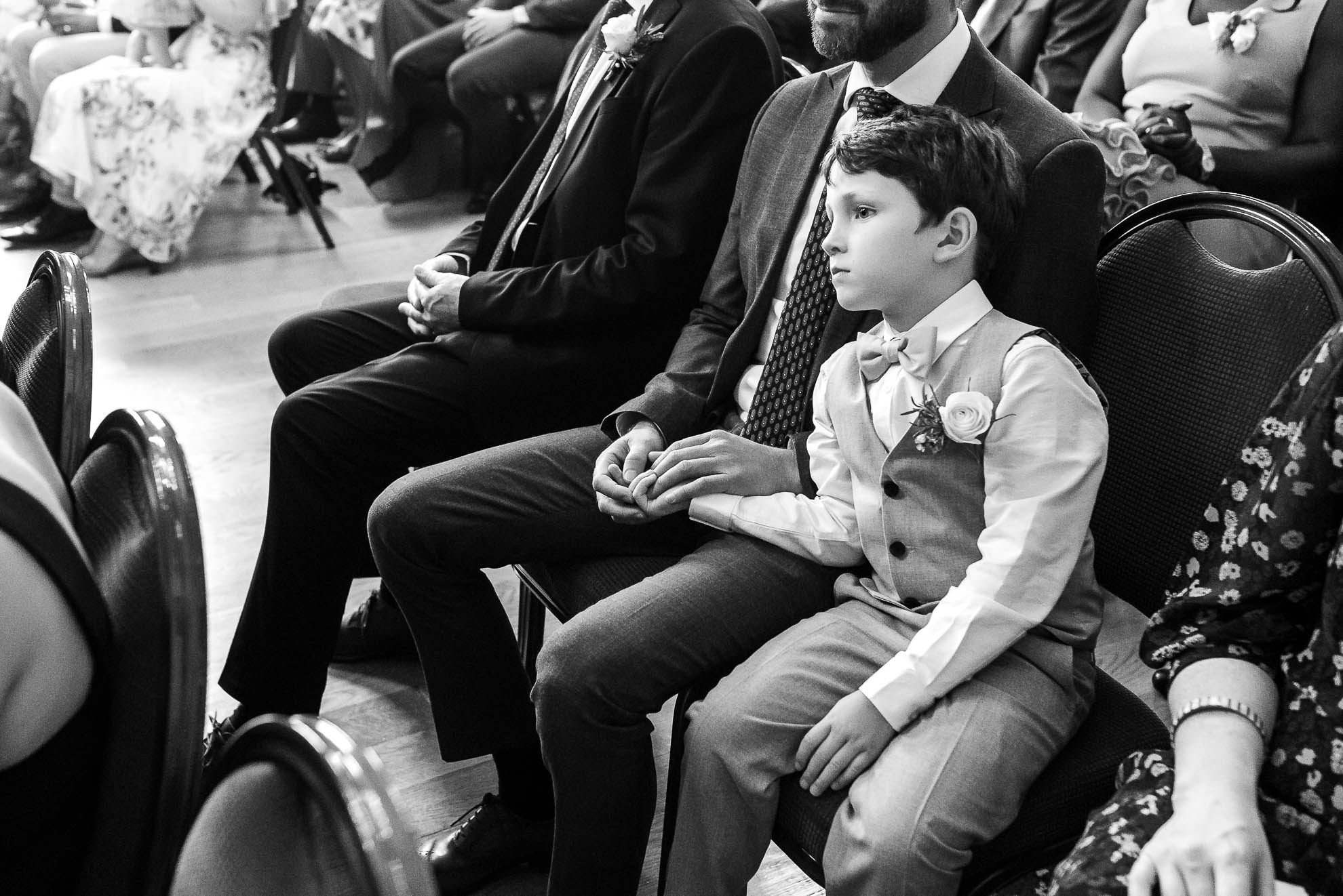 Page boy looks on during the vows
