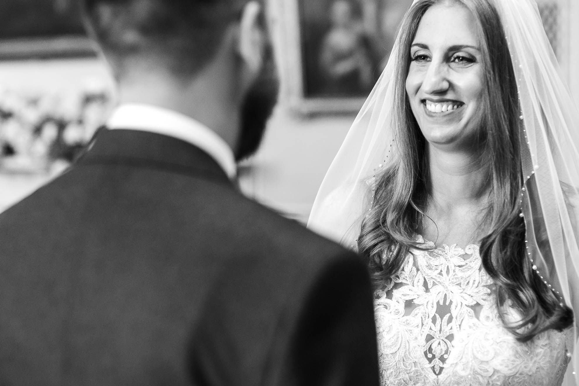 Bride smiles at Groom during vows