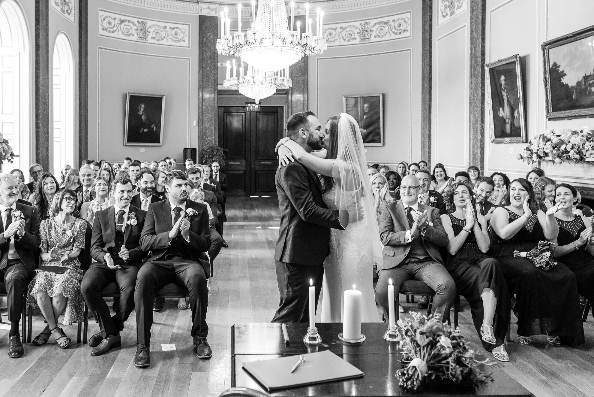 Bride and groom Kiss with the room cheering 
