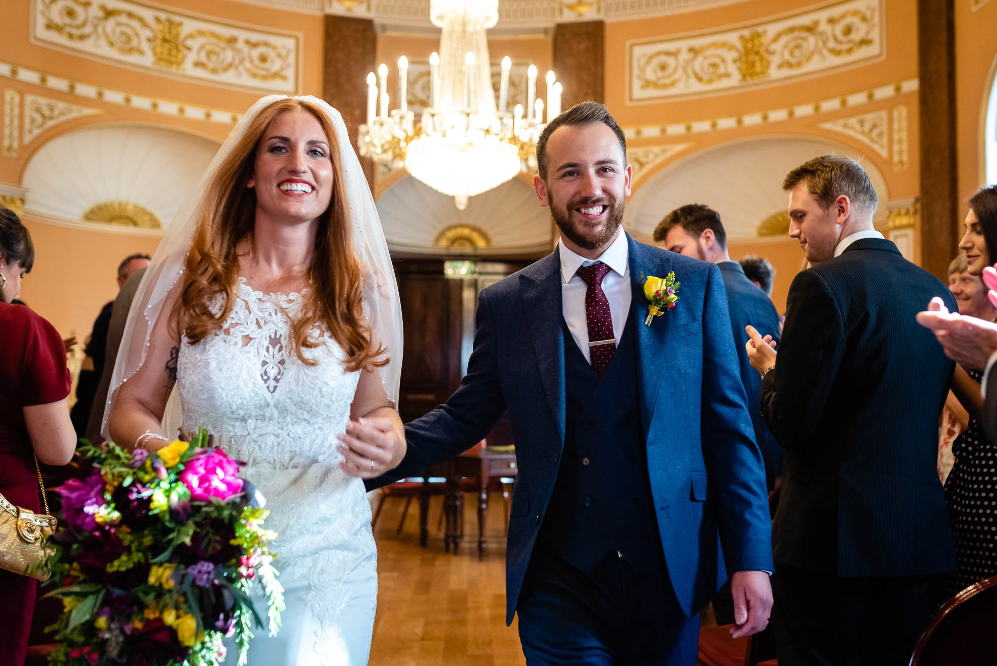 Bride and groom smiling as they walk back down the aisle