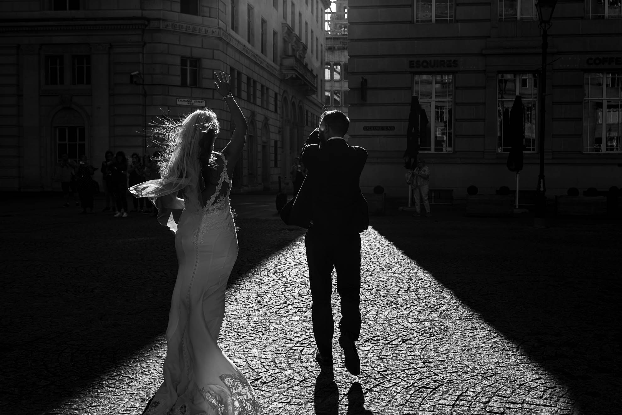 Bride and groom walk into Light