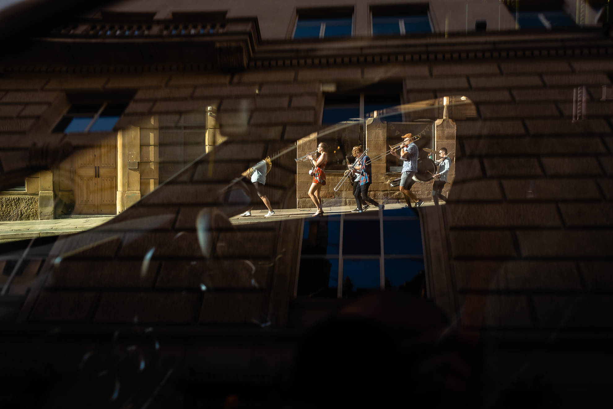 Brass band framed by a car window