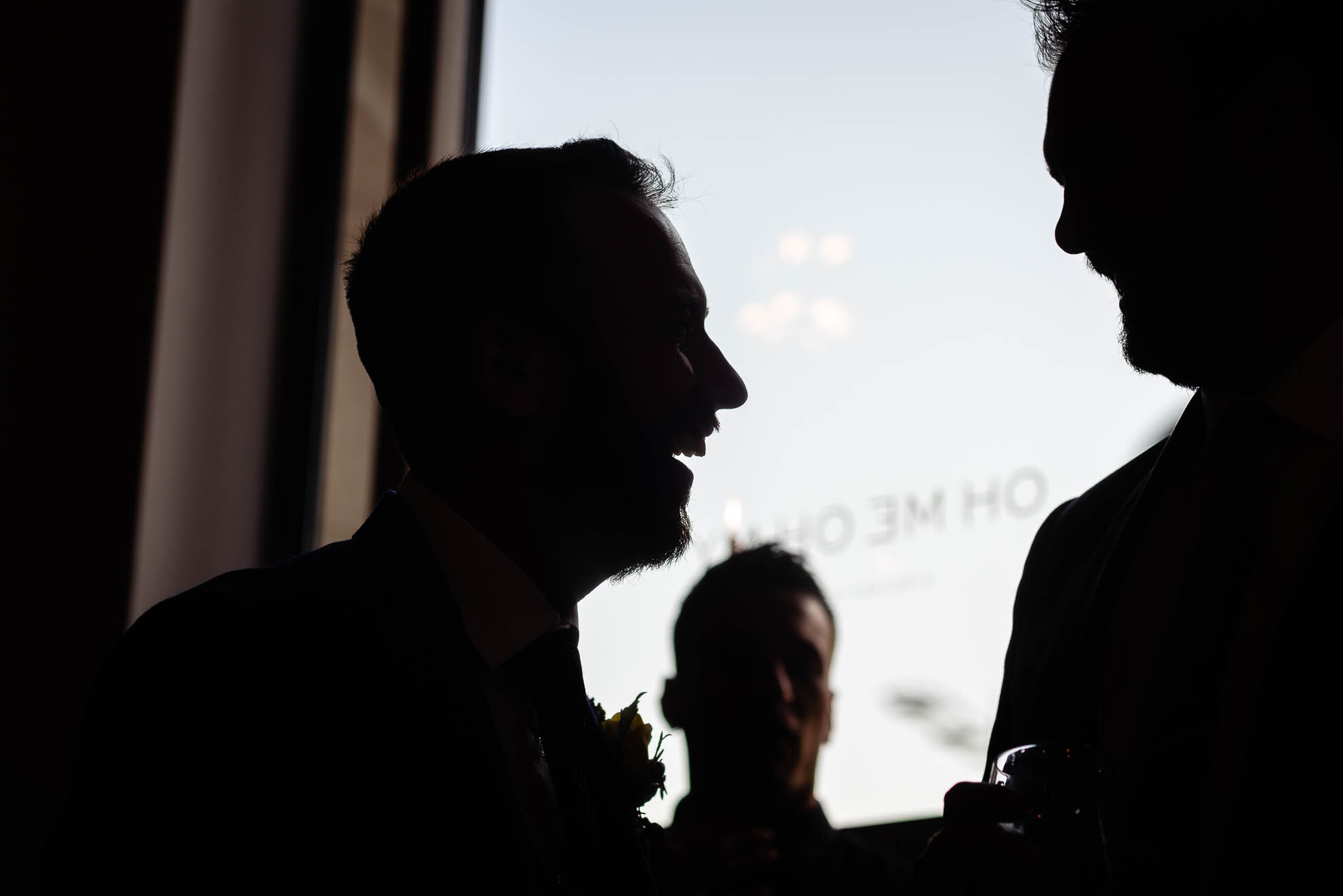 silhouette of groom with guest