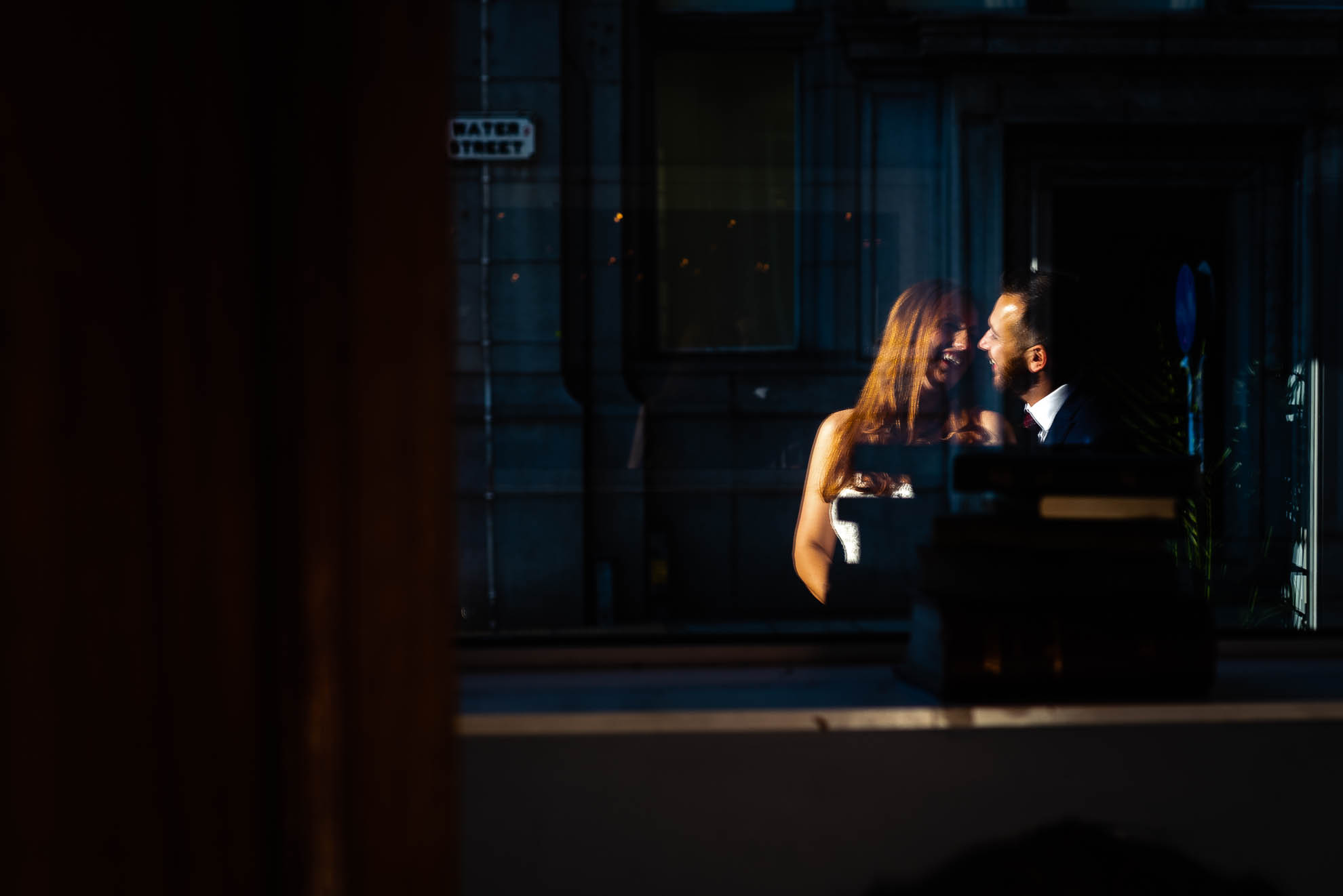 Bride and groom portrait in window