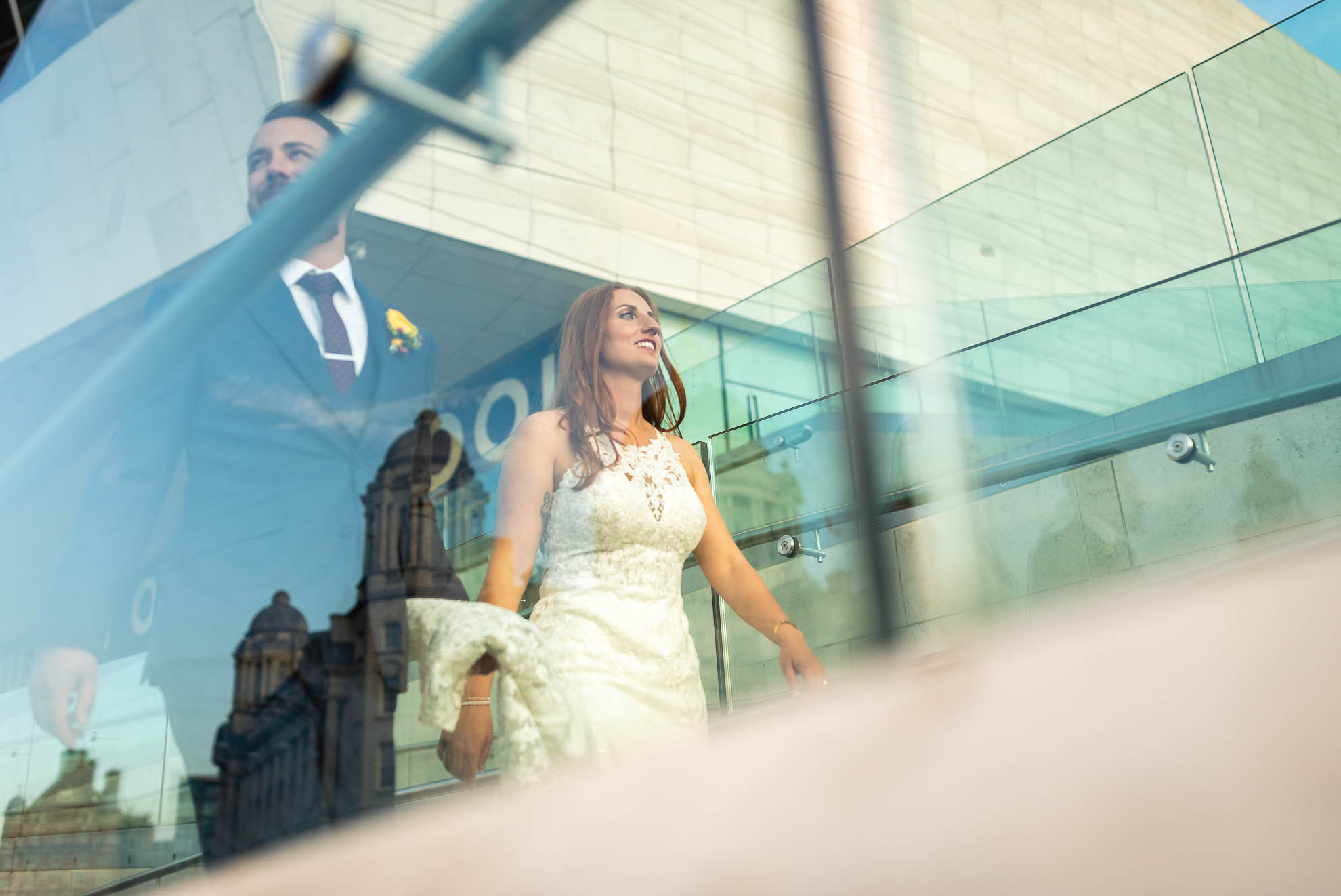 Bride and groom walking past Liverpool Museum