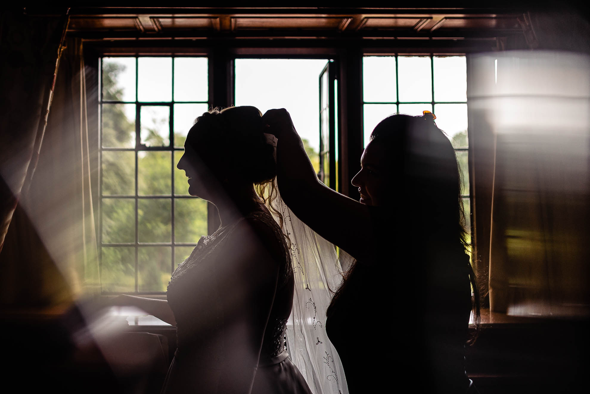 Bride putting on veil