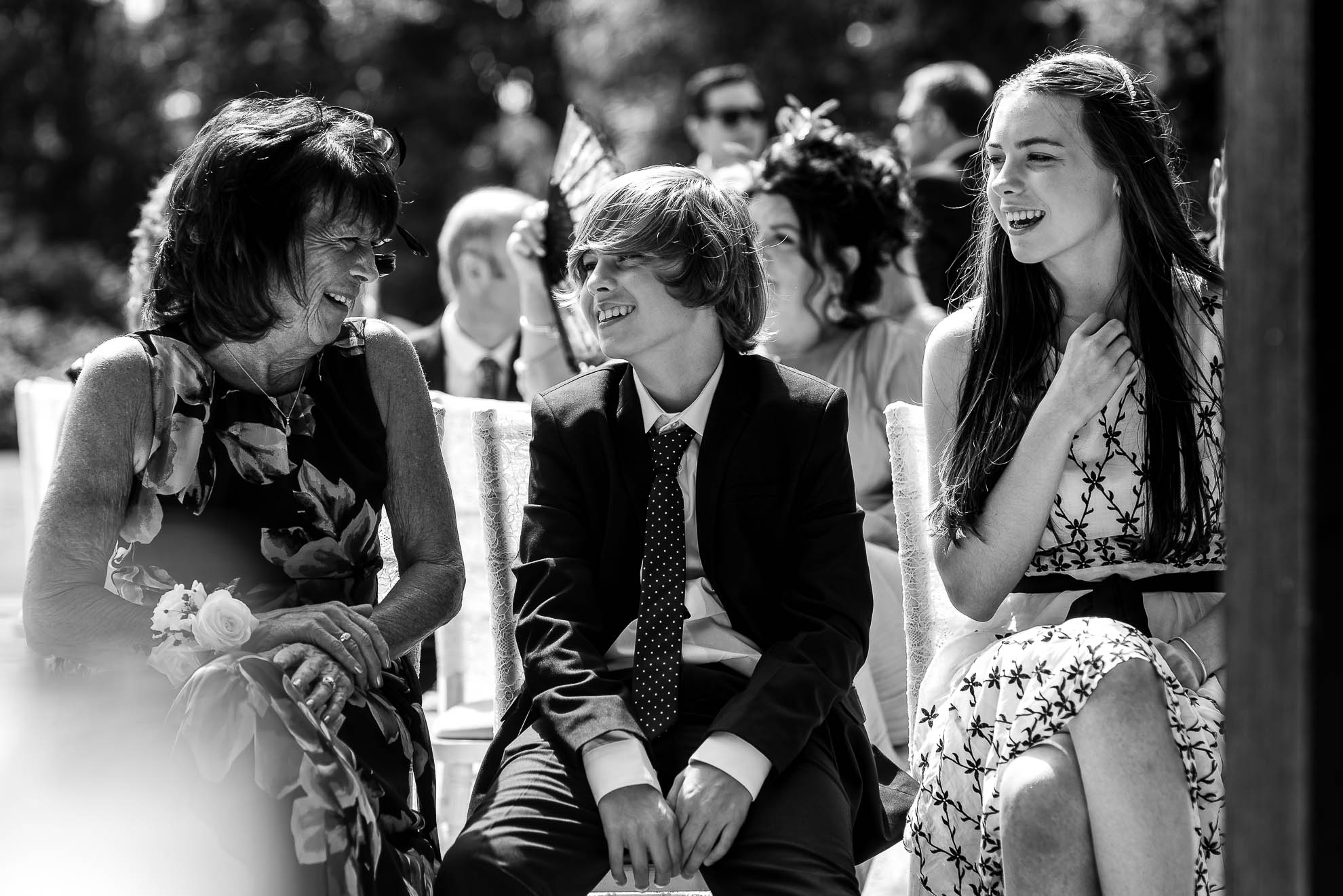 Mother of the groom shares a joke with grooms children