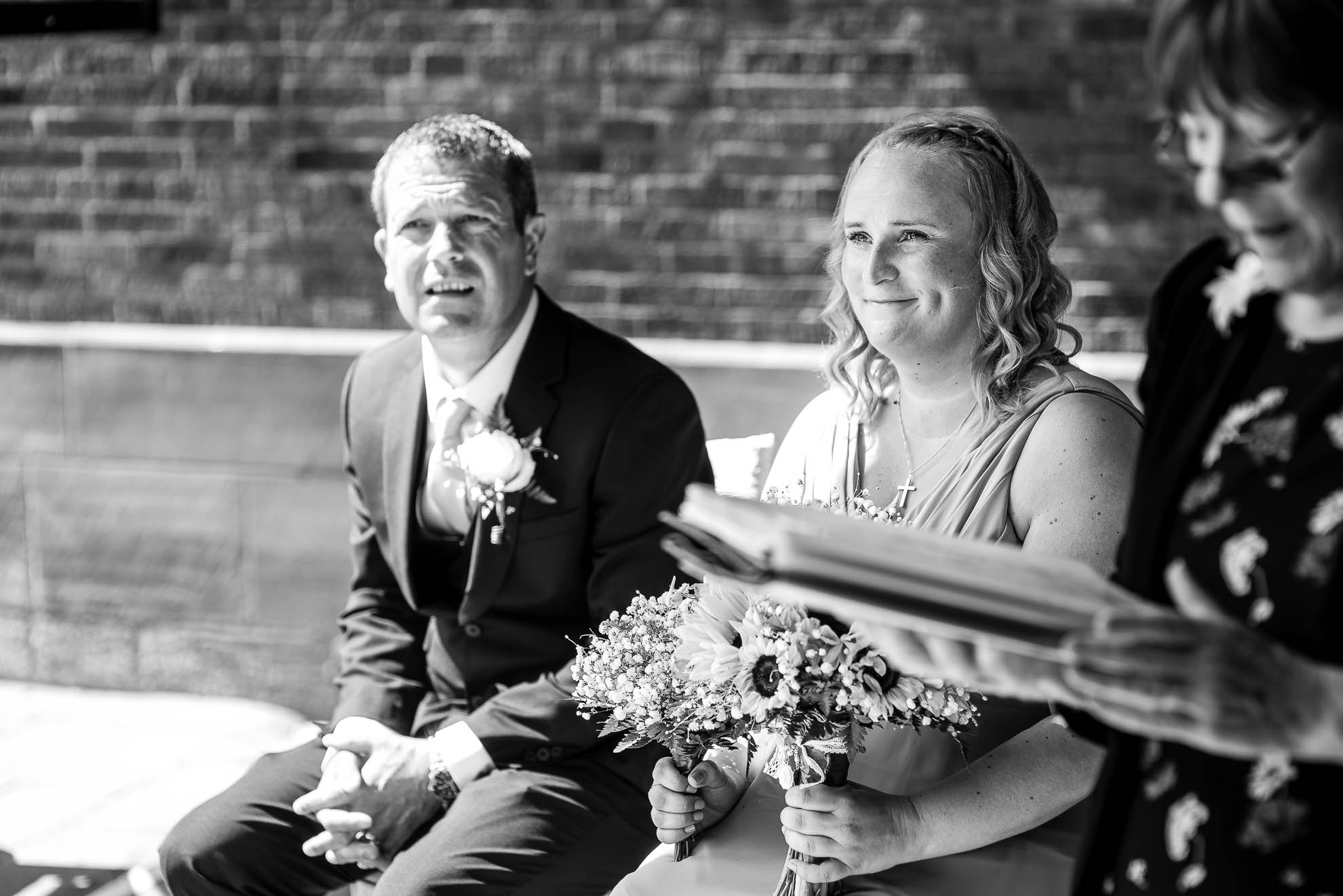 Bridesmaid smiles during ceremony