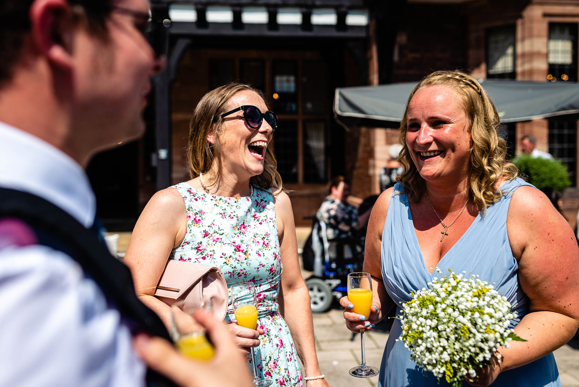 Guest share a joke with bridesmaid