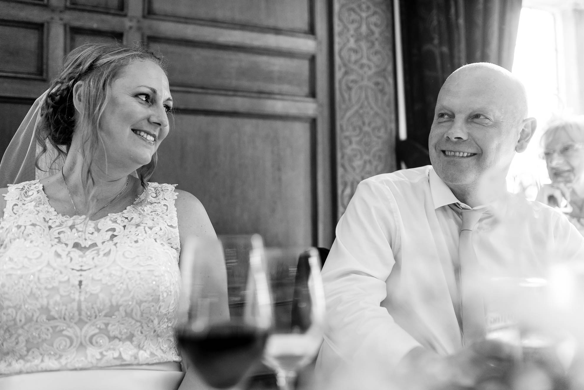Bride and groom laughing at speech