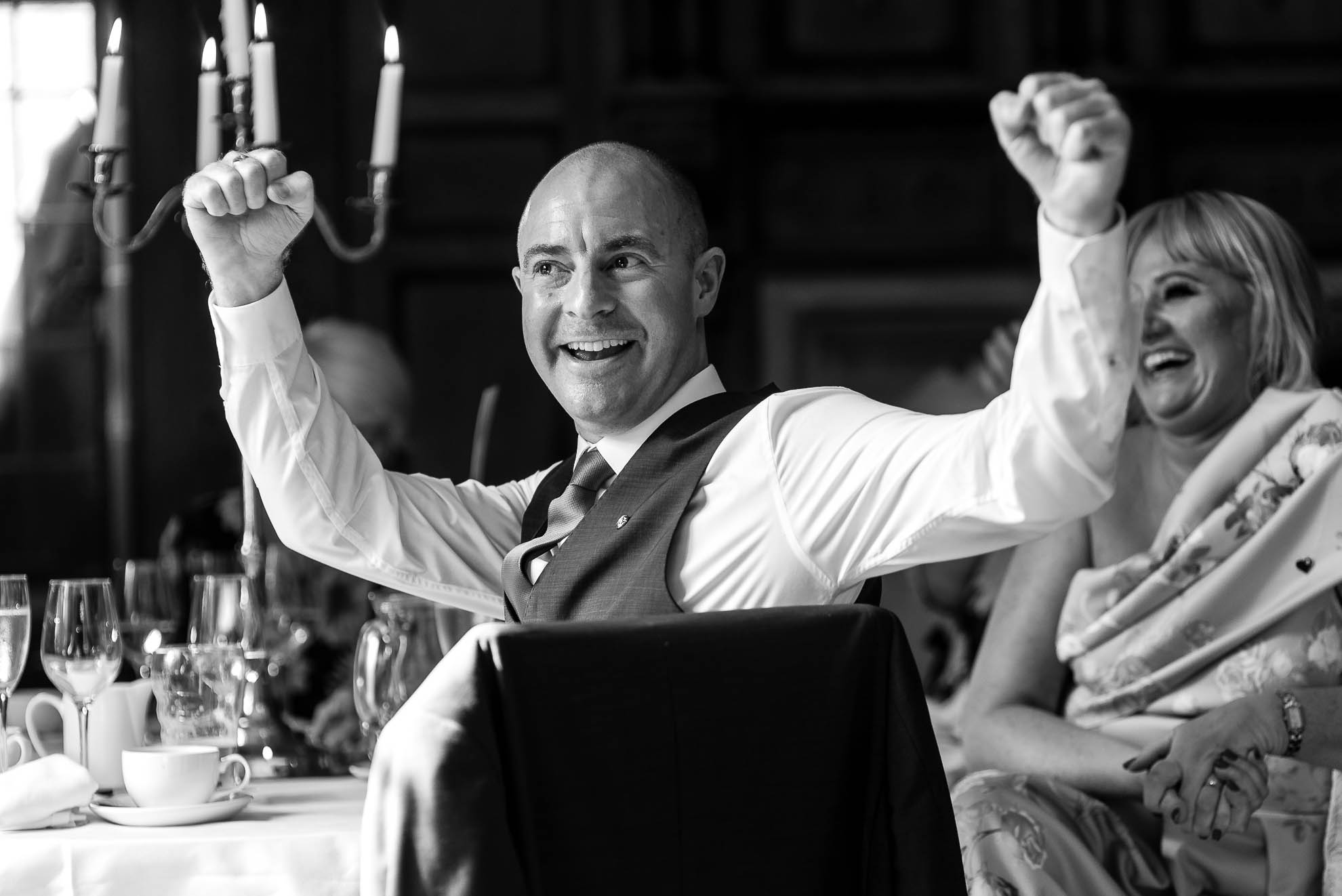 Guest raising arms and laughing