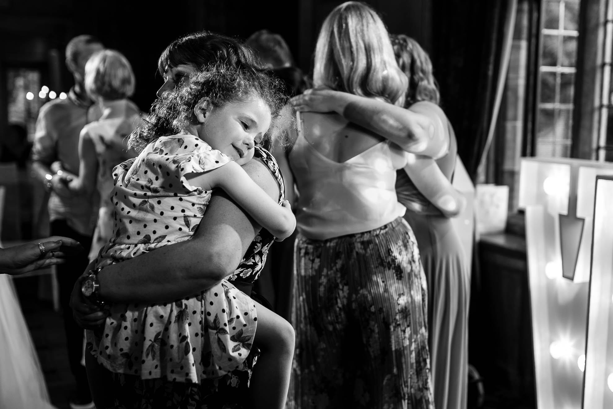 Flower girl enjoying dancing with her mother