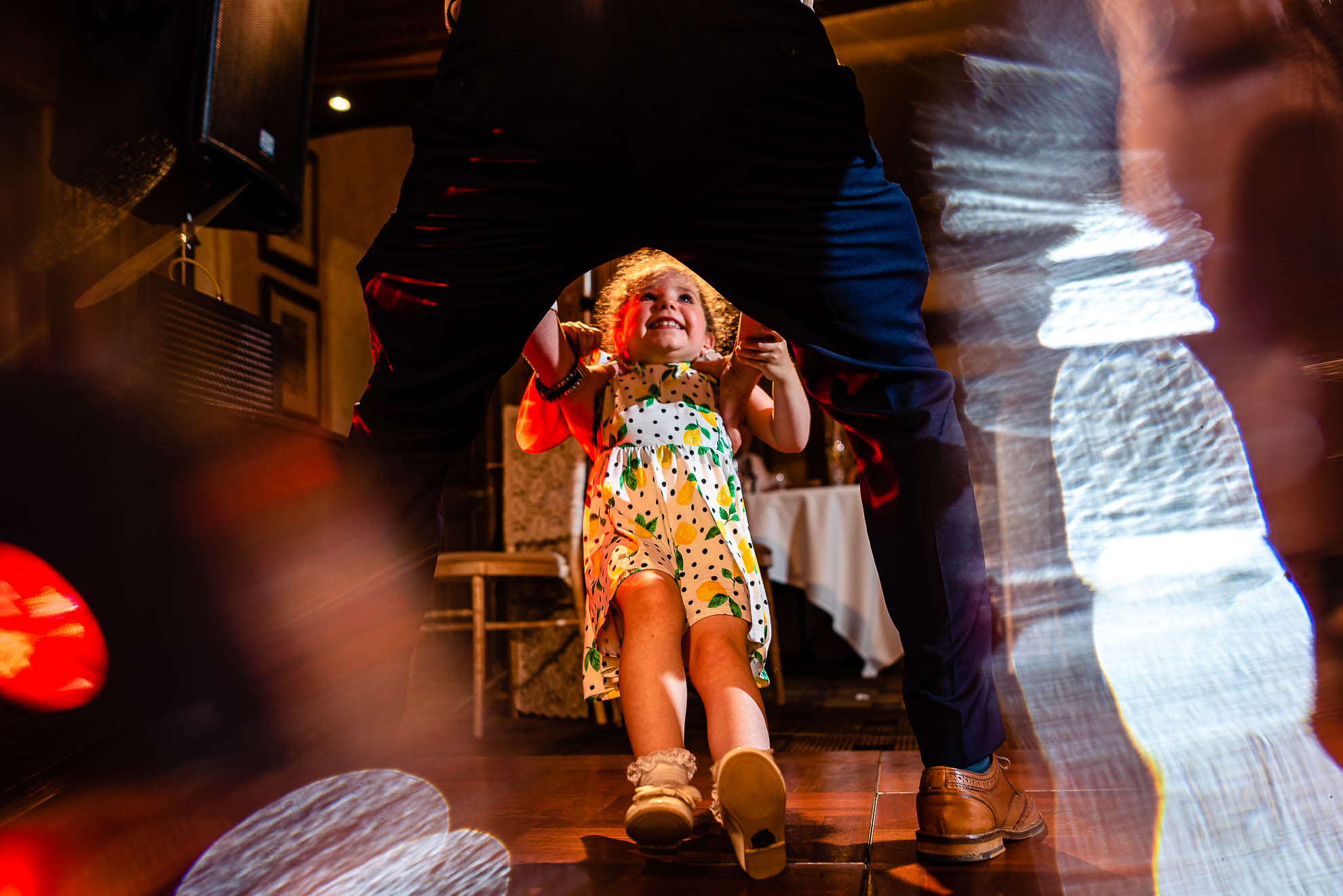 Groom dances with flower girl