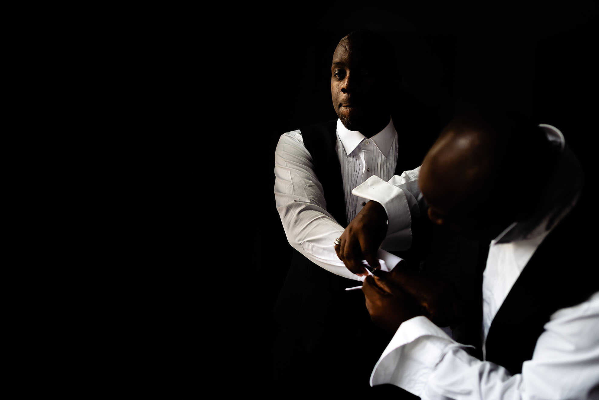 best man helps the groom dress