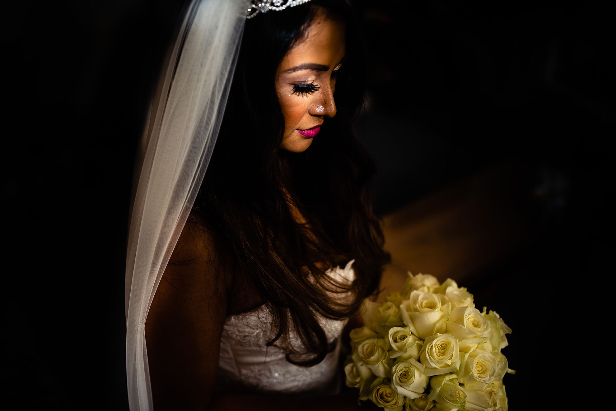Bride looks at her bouquet