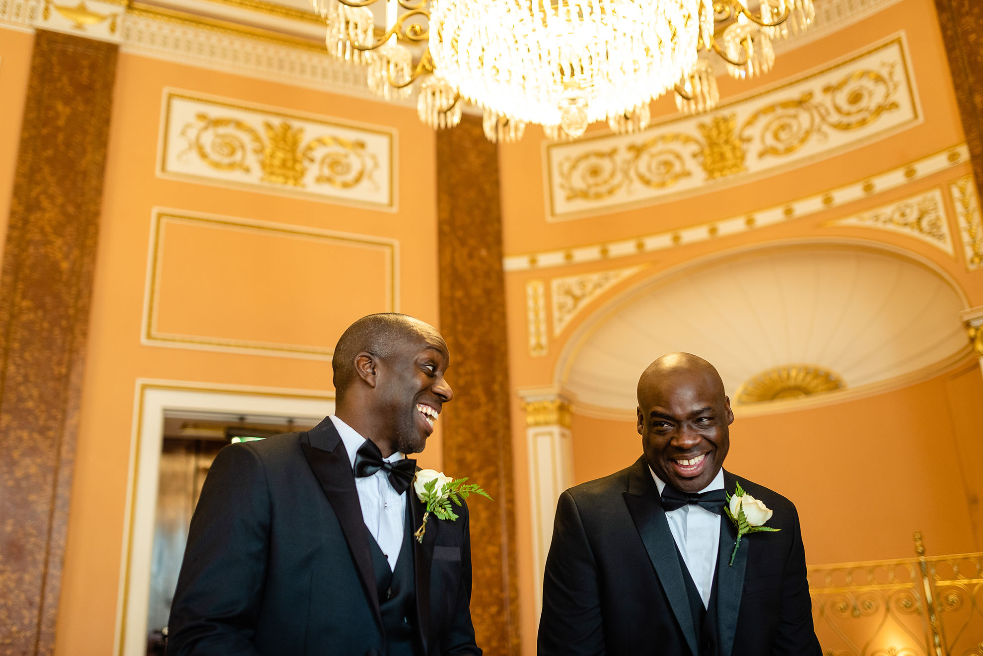 groom shares a joke with his best man