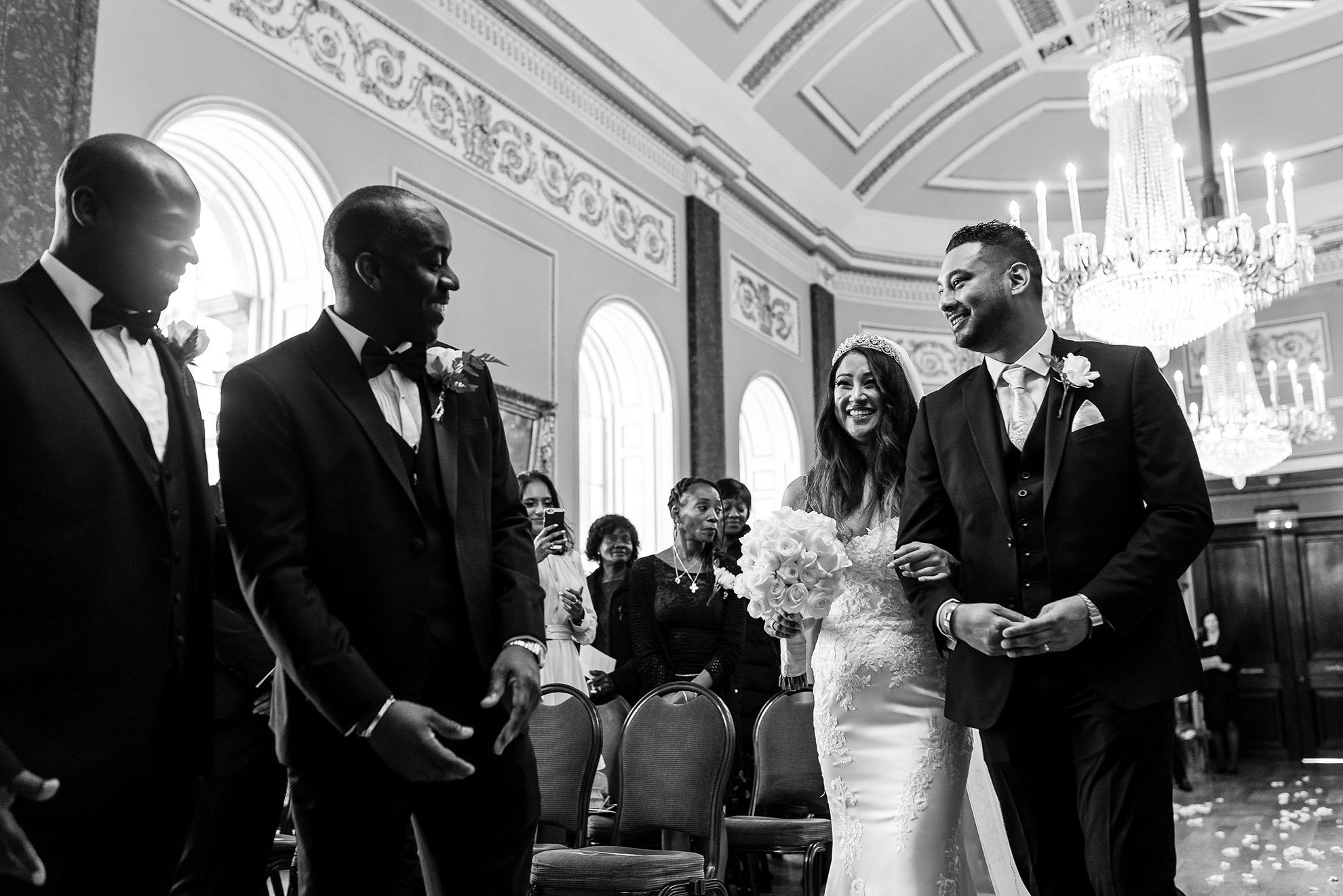 Groom greets his bride as she arrives at the altar