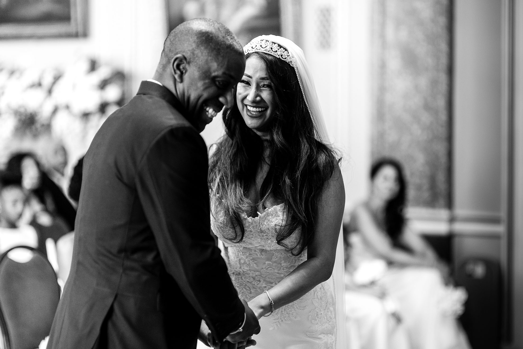 The Bride and groom share a joke during the exchange of rings