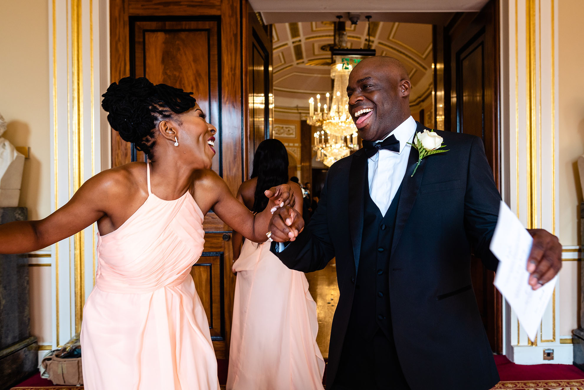 Chief bridesmaid and best man share a joke 