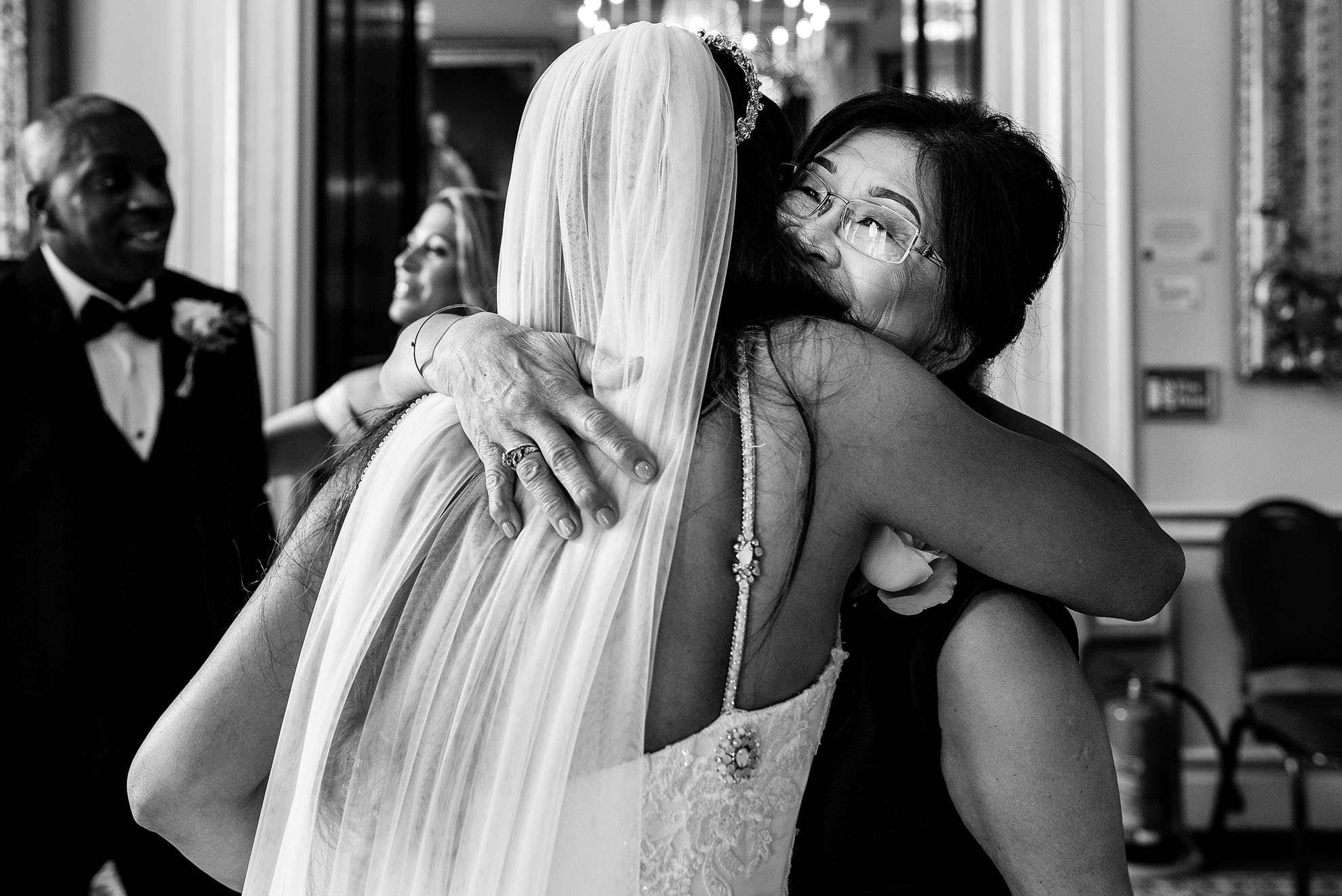 Mother of the bride gives the bride a hug