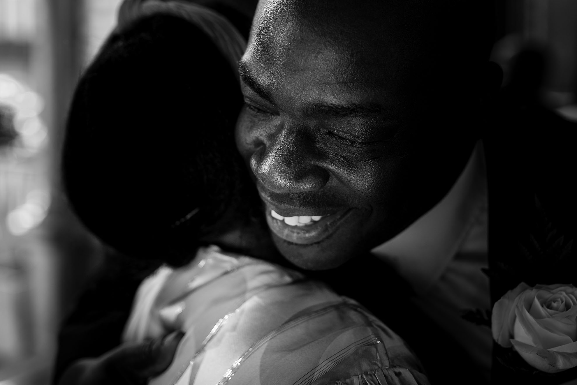 Best man hugs a wedding guest