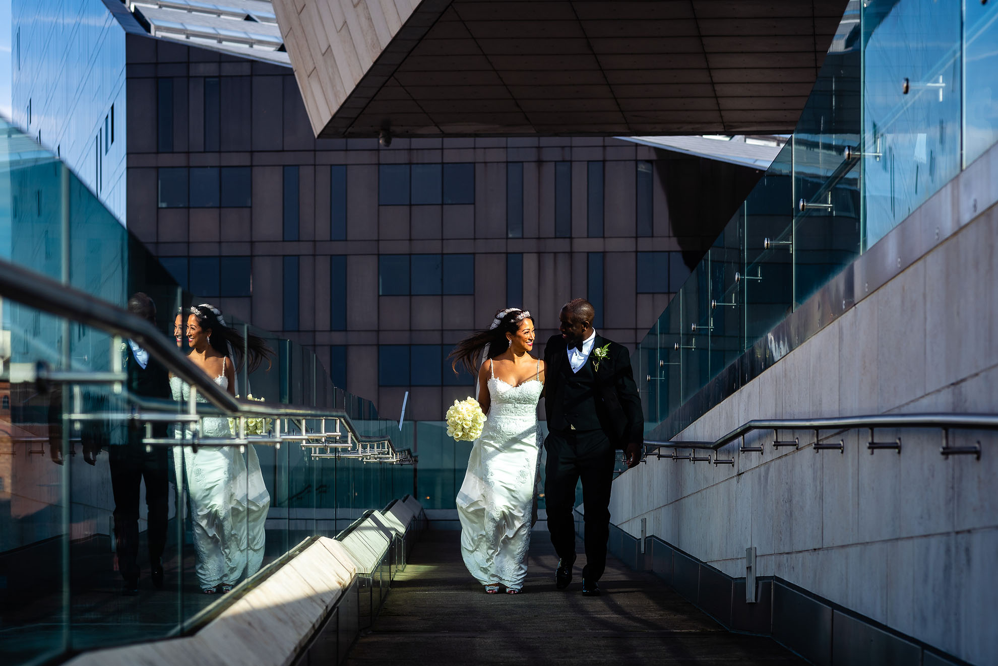 Bride and groom share a joke as the walk together