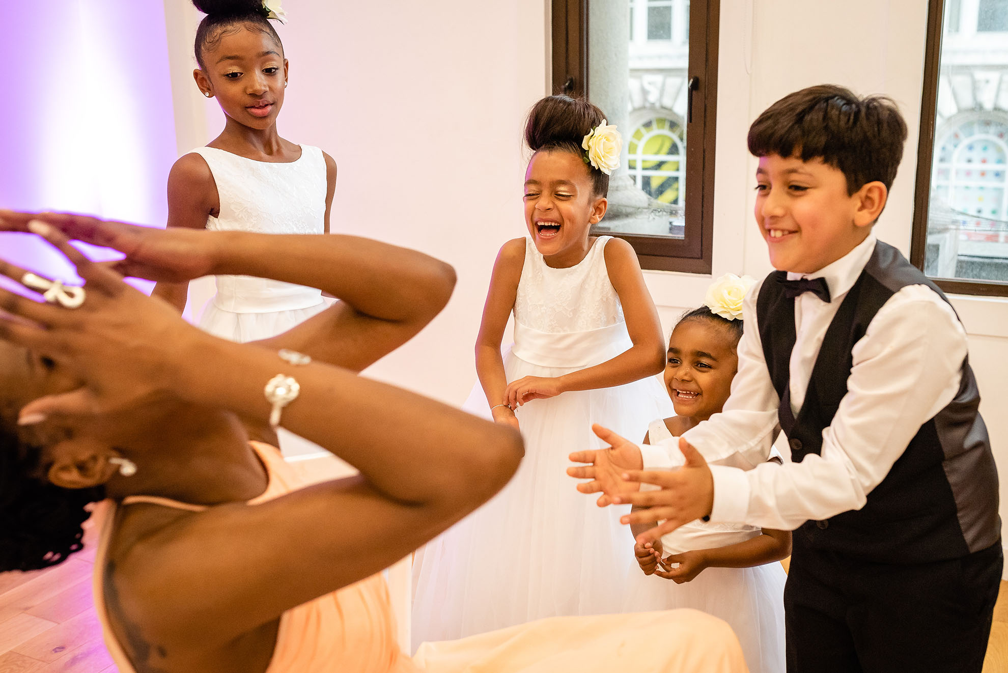 Bridesmaid shares a joke with children