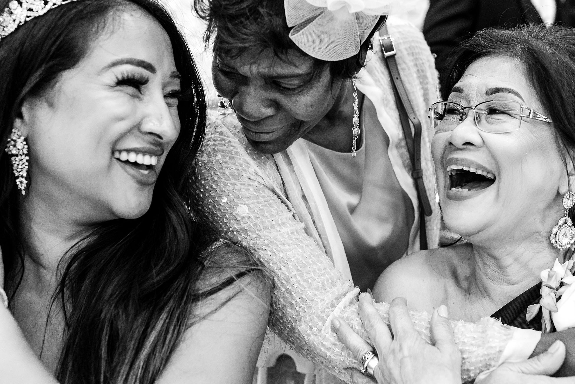 Bride and mother of the bride share a joke with guest