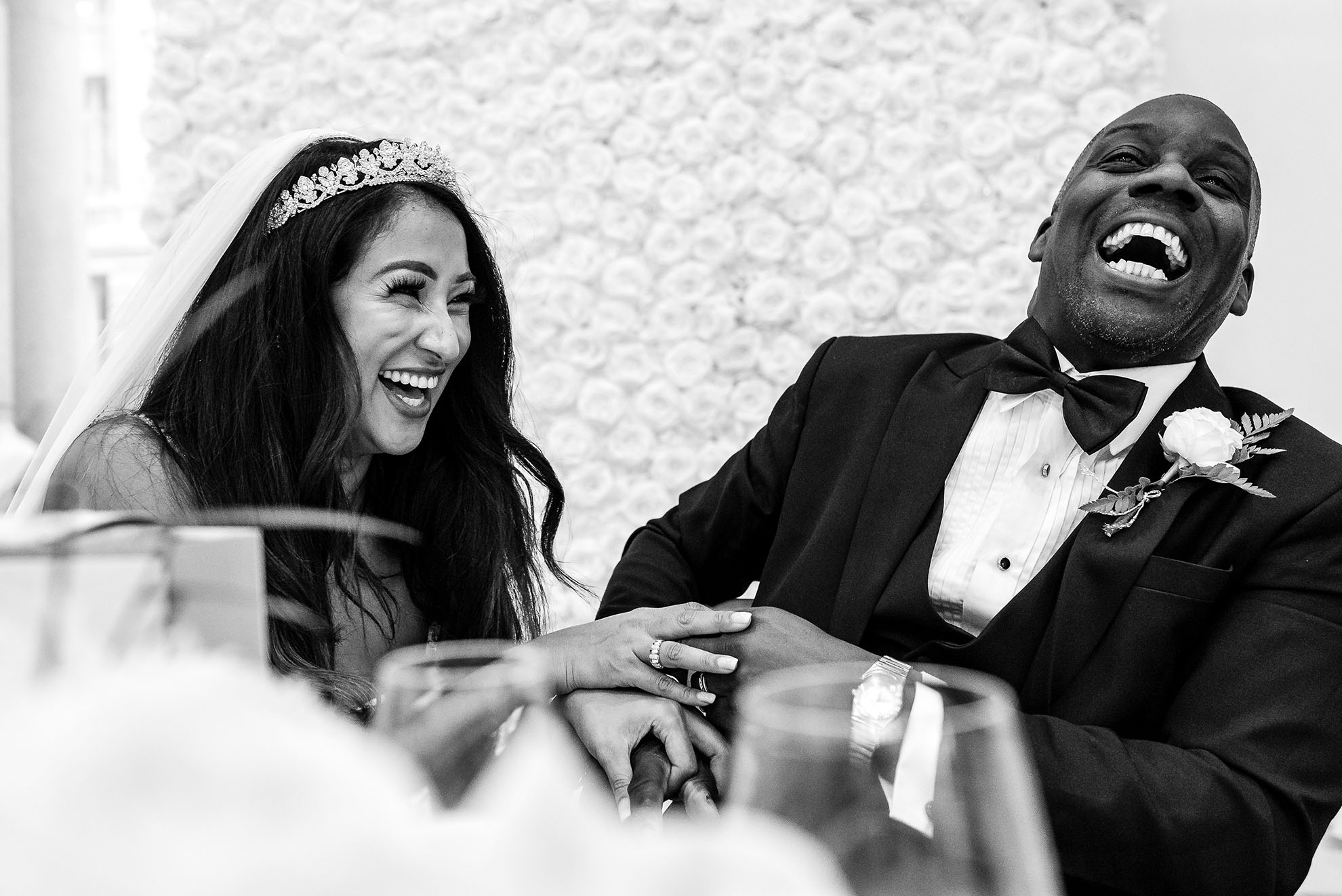 The happy couple laugh at guests joke