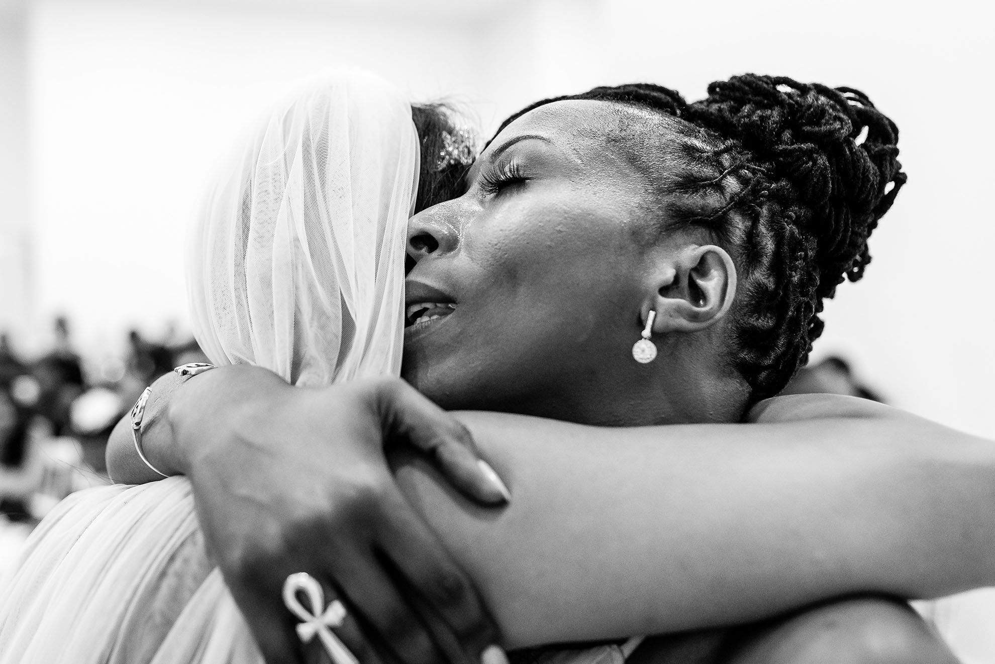 Chief bridesmaid hugs bride after her speech