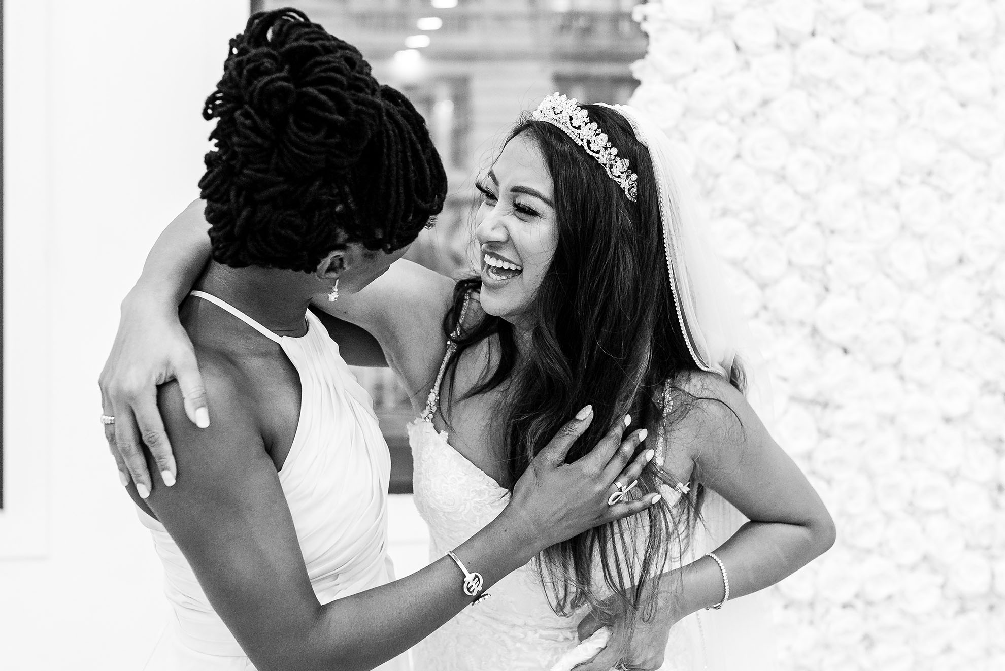 Chief bridesmaid and bride share a joke