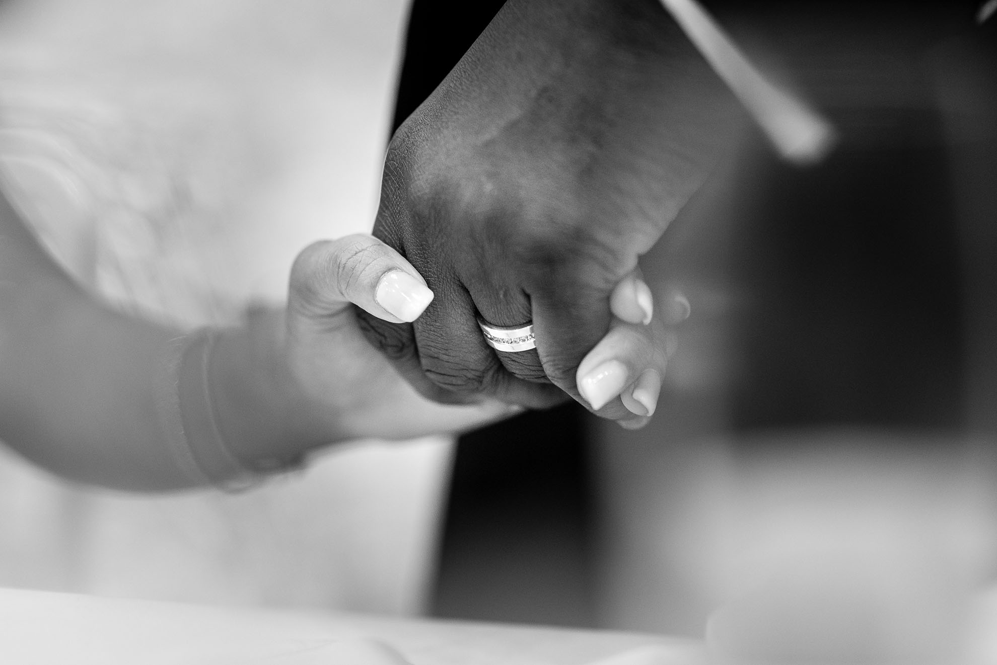 bride and groom hold hands