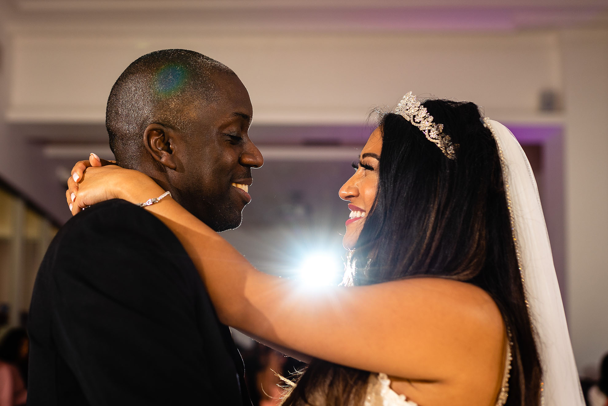 Bride and groom smile during the first dance