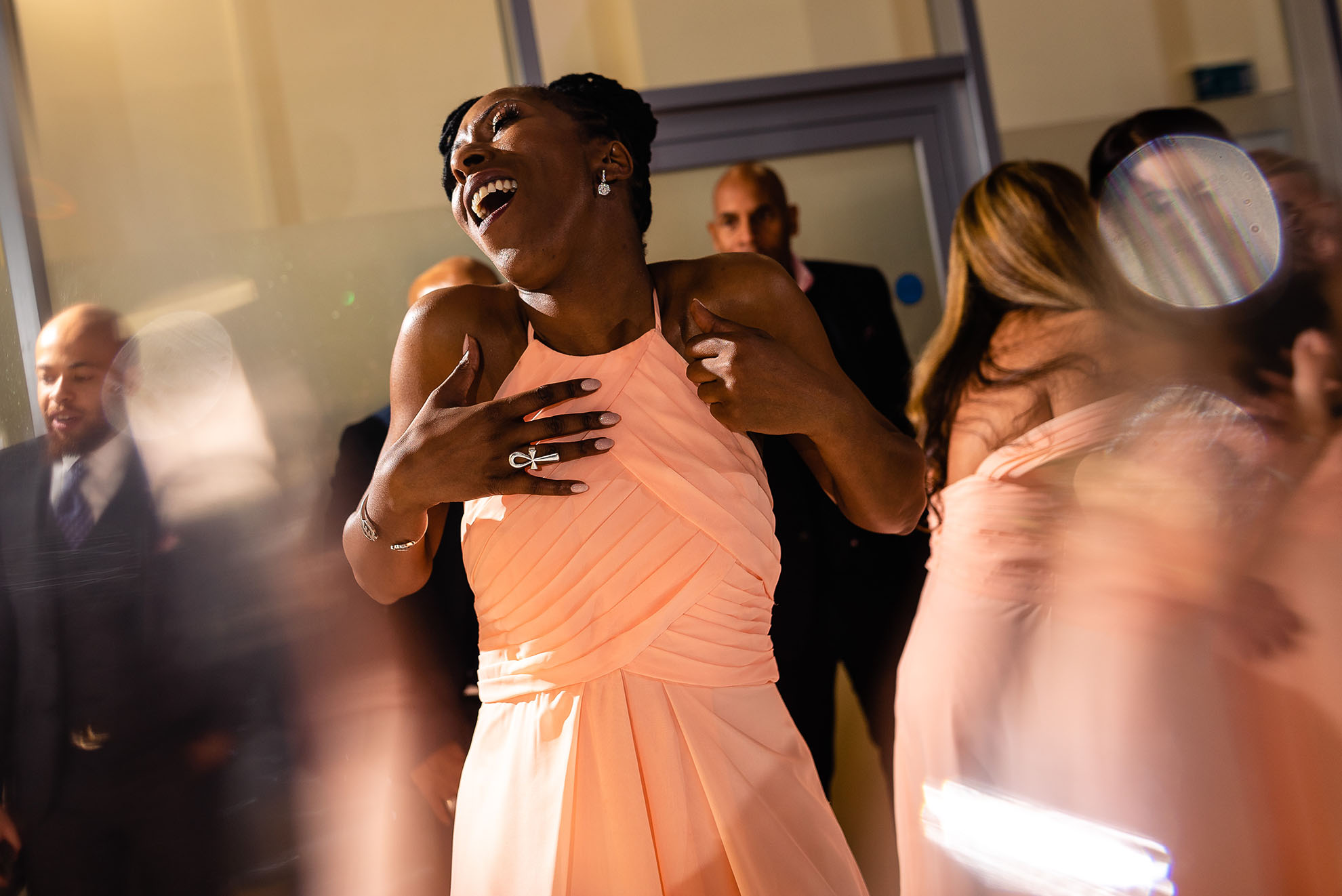 Chief bridesmaid singing as she dances