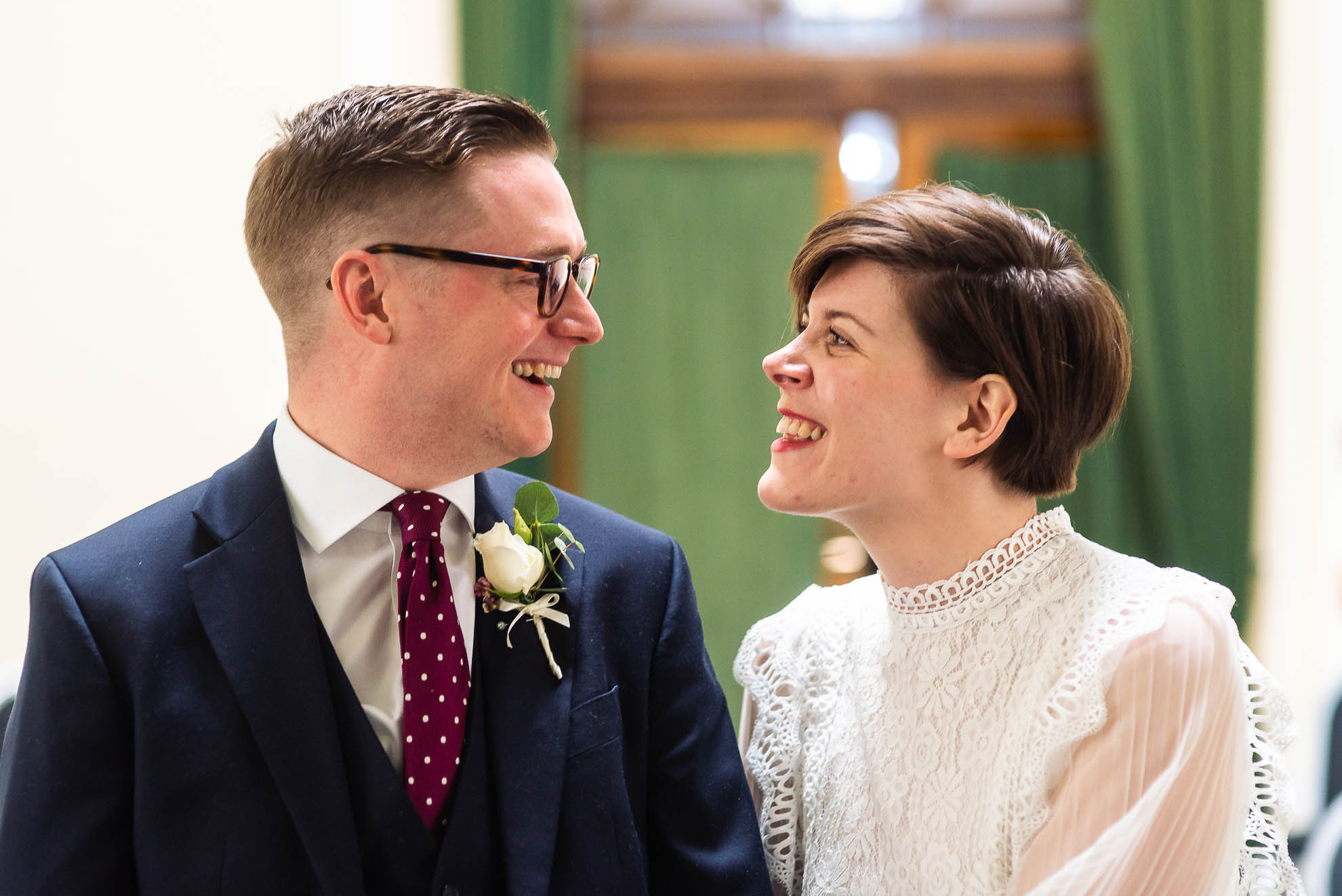 Bride and groom smile at each other