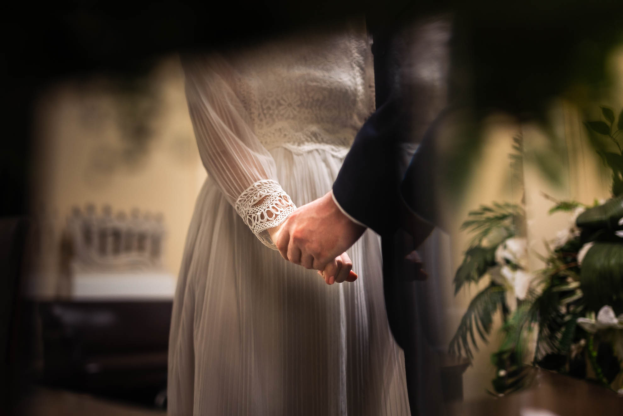bride and groom hold hands during ceremony