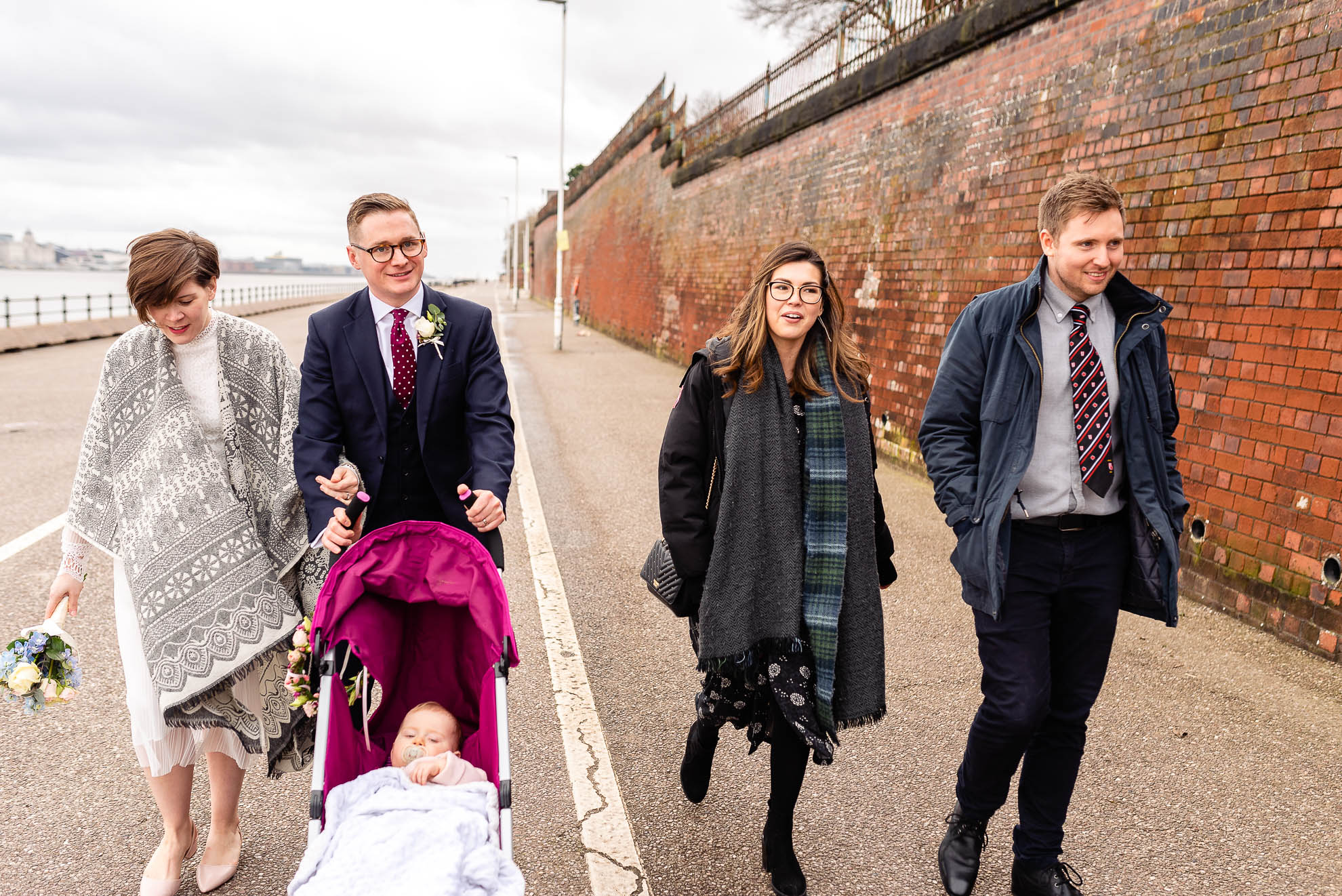 Wedding party walk along Mersey waterfront